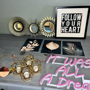Many items for a girl’s or woman’s bedroom including neon sign and pictures